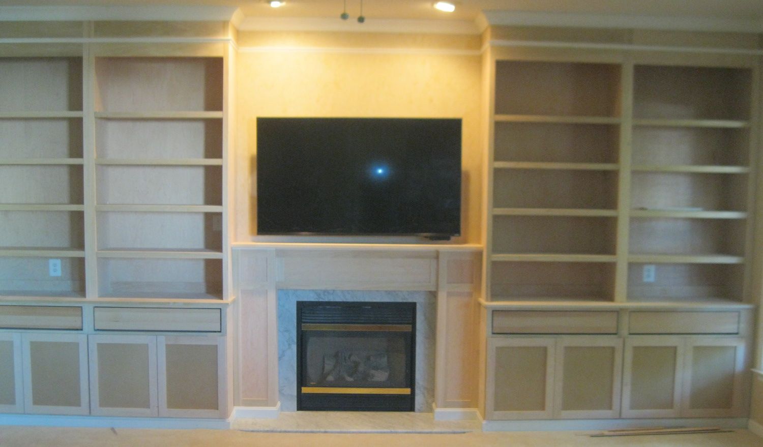 Unfinished Shelving with Storage and Fireplace mantel